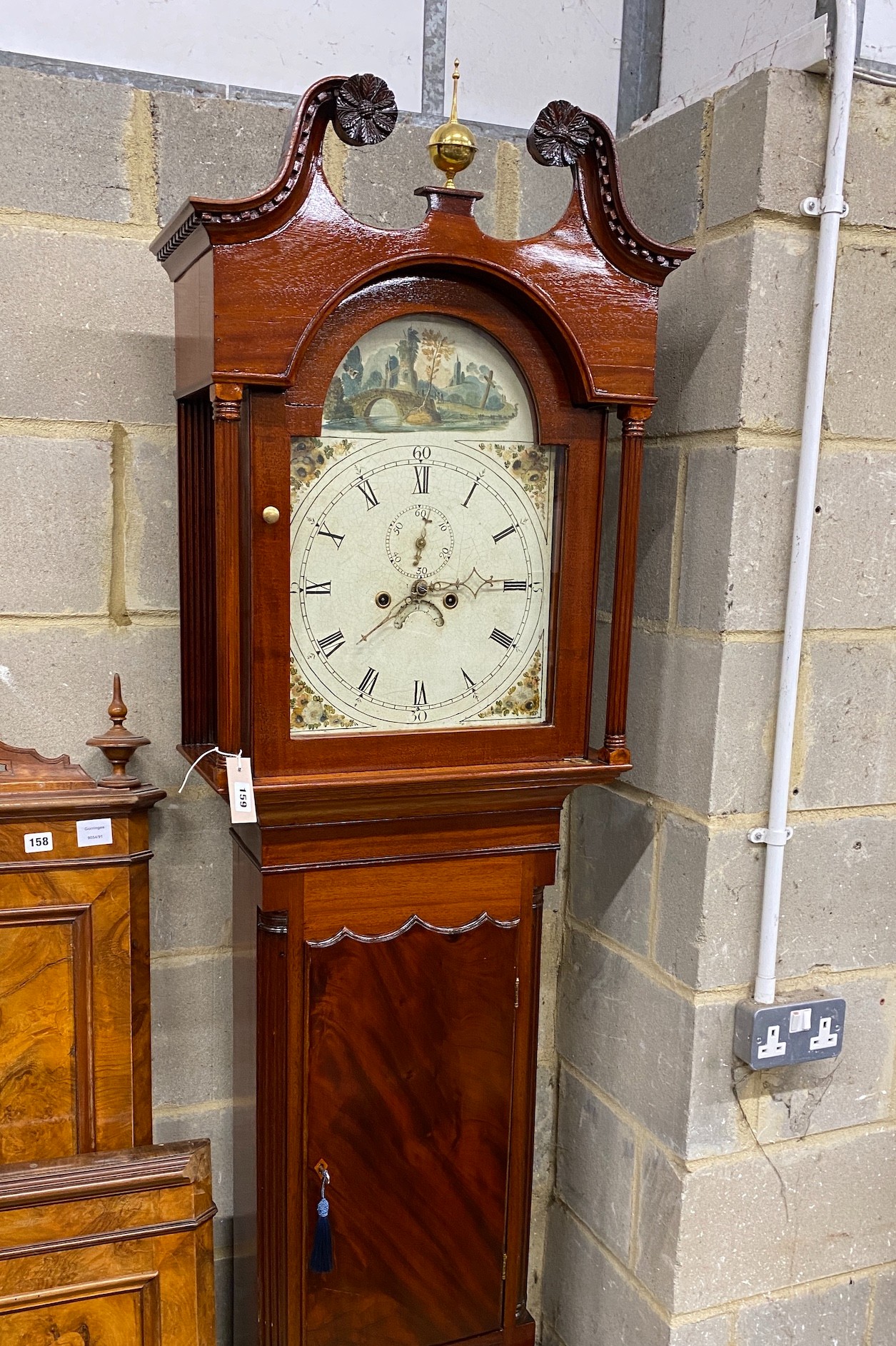 An early 19th century mahogany eight day longcase clock with painted arched dial, height 218cm
